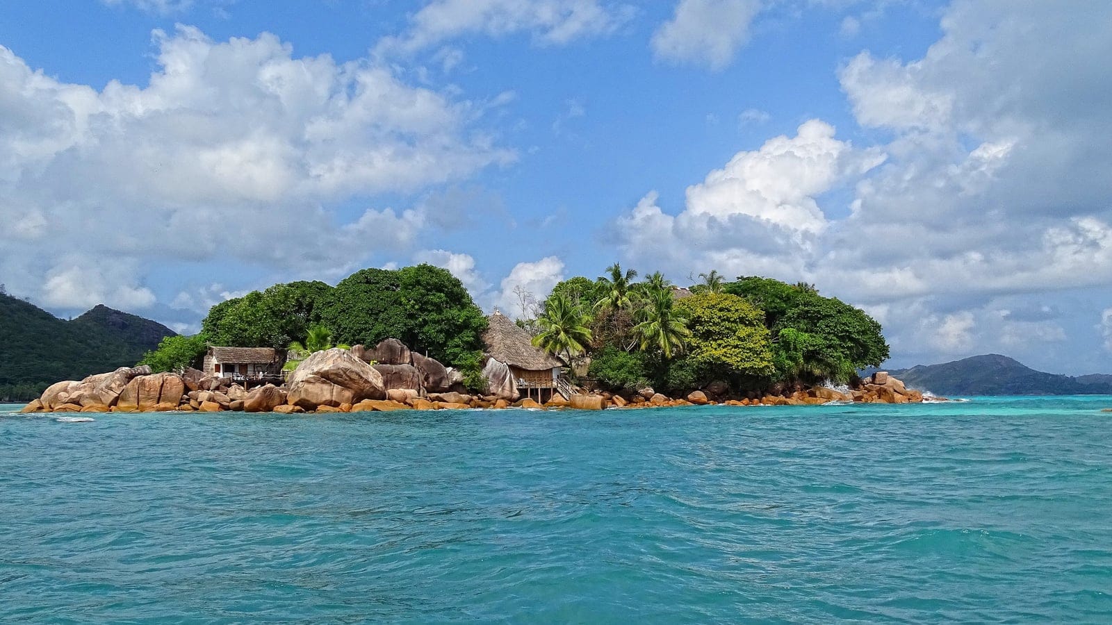 Granite boulders and palm topped vegetation on the islet of Chauve-Souris off Praslin, Seychelles.