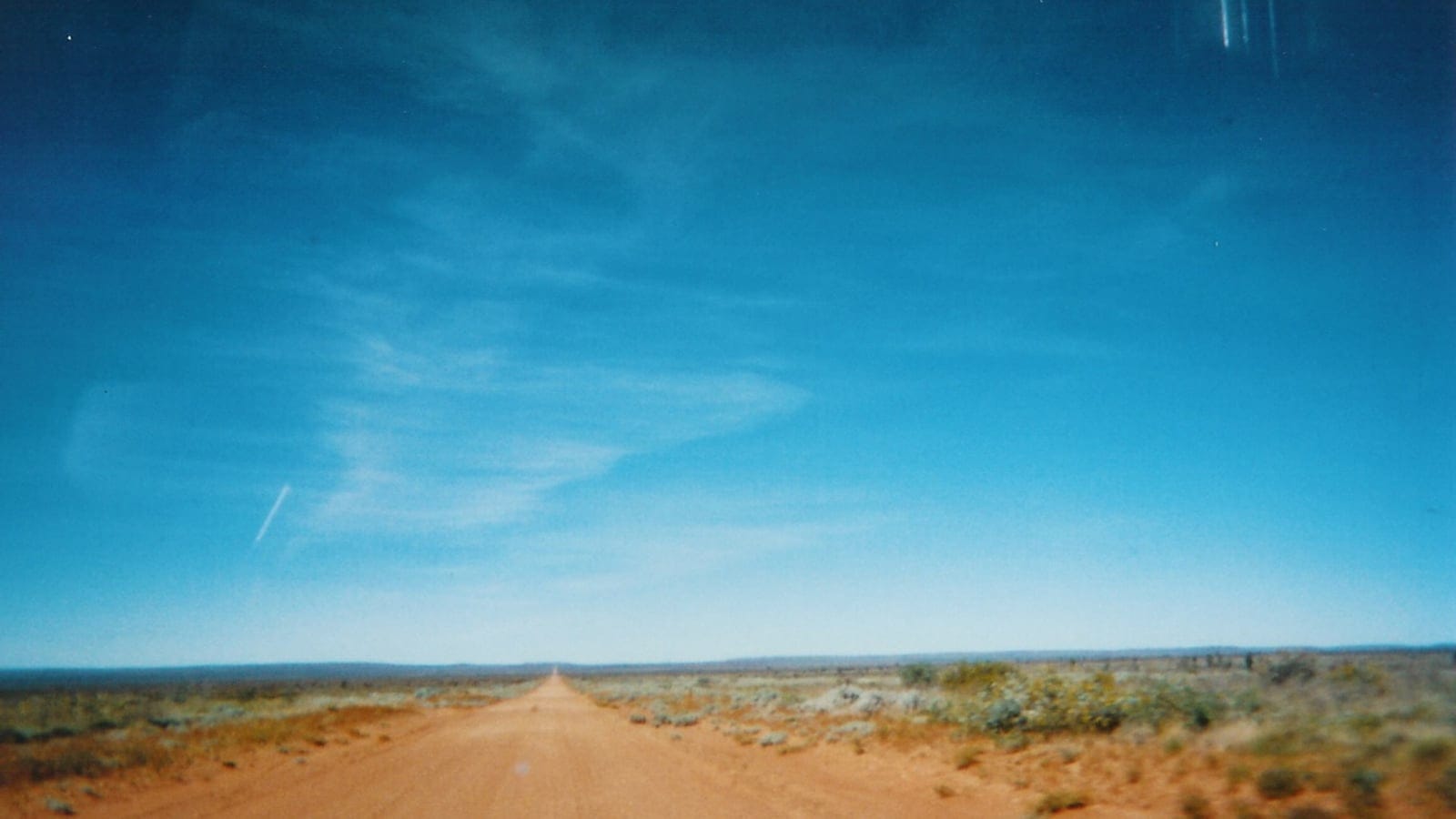 Red sand track through spinifex and low shrubs in the Tanami Desert, Northern Territory.