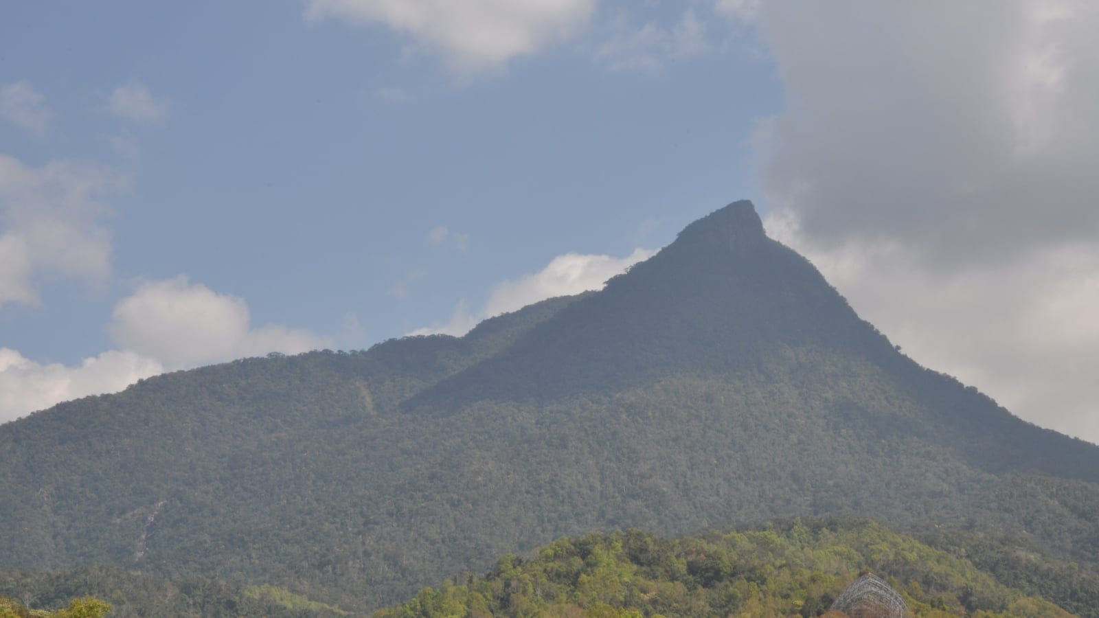 Forested slopes of Wuzhi Mountain rising above lowland hills, Hainan, China.