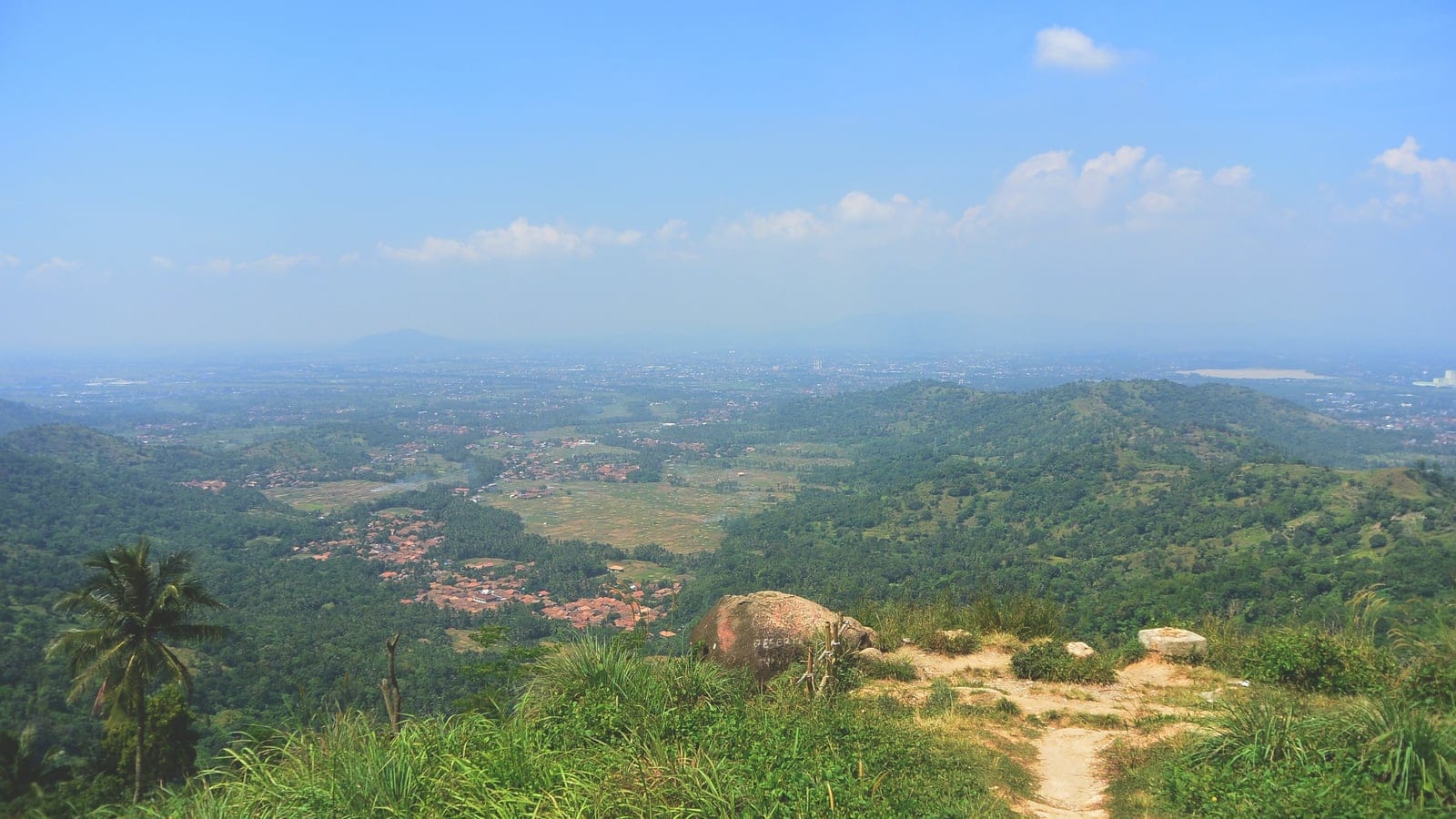View from Batu Lawang over wooded hills, villages and rice fields toward the Banten lowland, Indonesia.