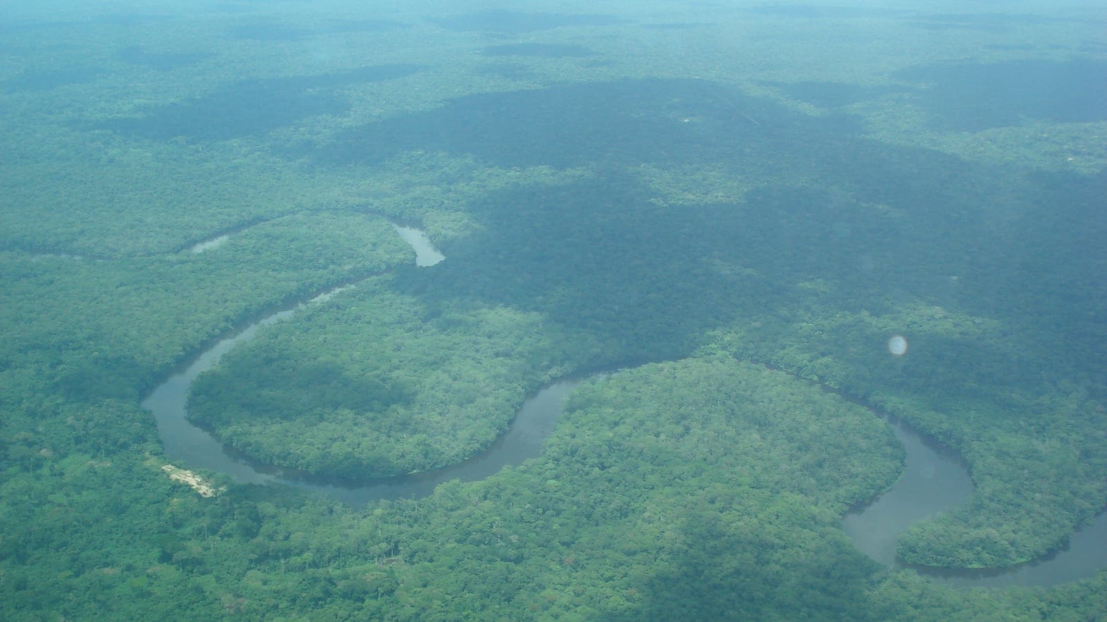 Aerial view of the Lukenie River winding through Central Congolian lowland forest canopy.