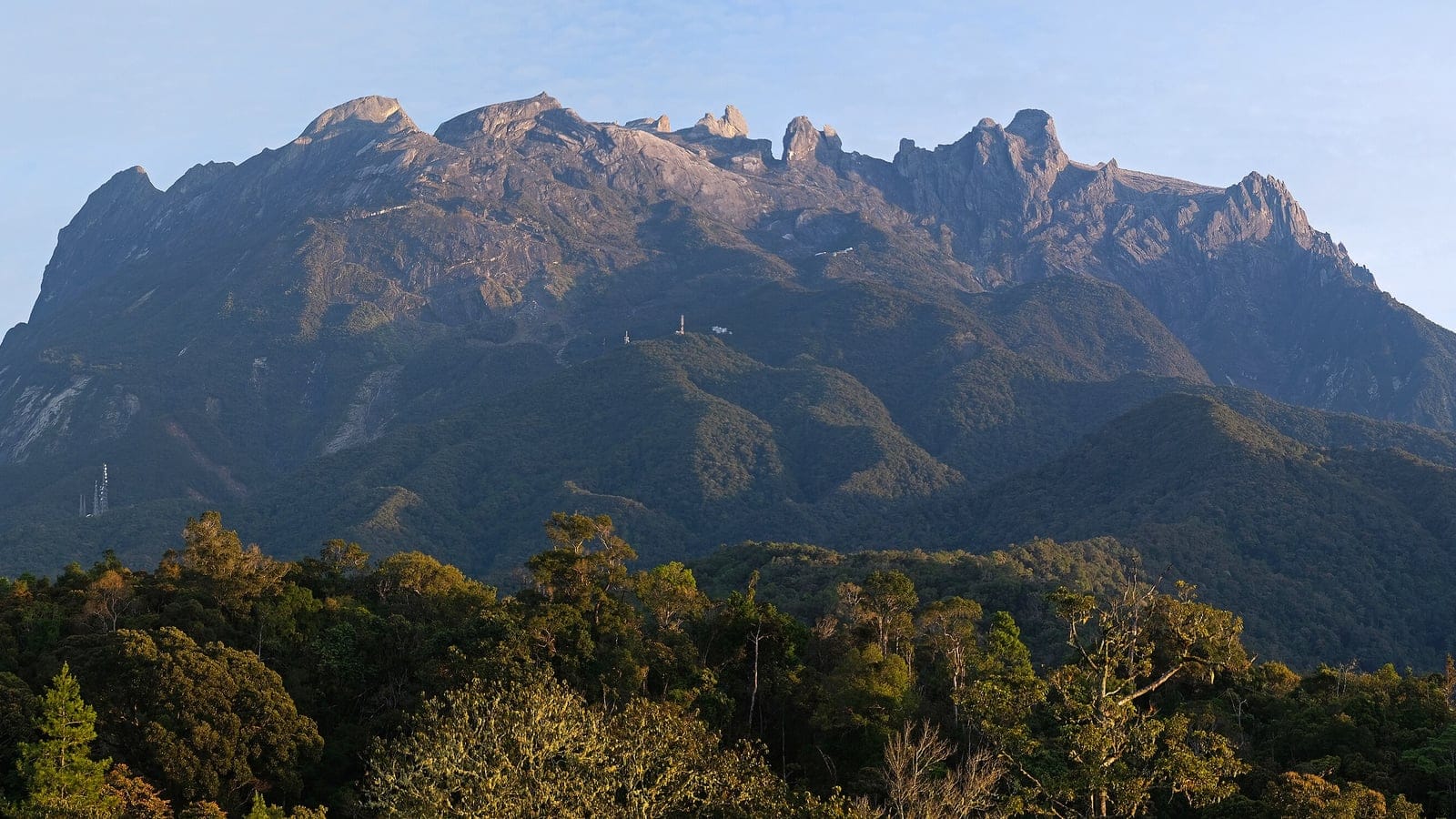 Bare granite summit of Mount Kinabalu above montane forest, seen from Kundasang, Sabah, Borneo.