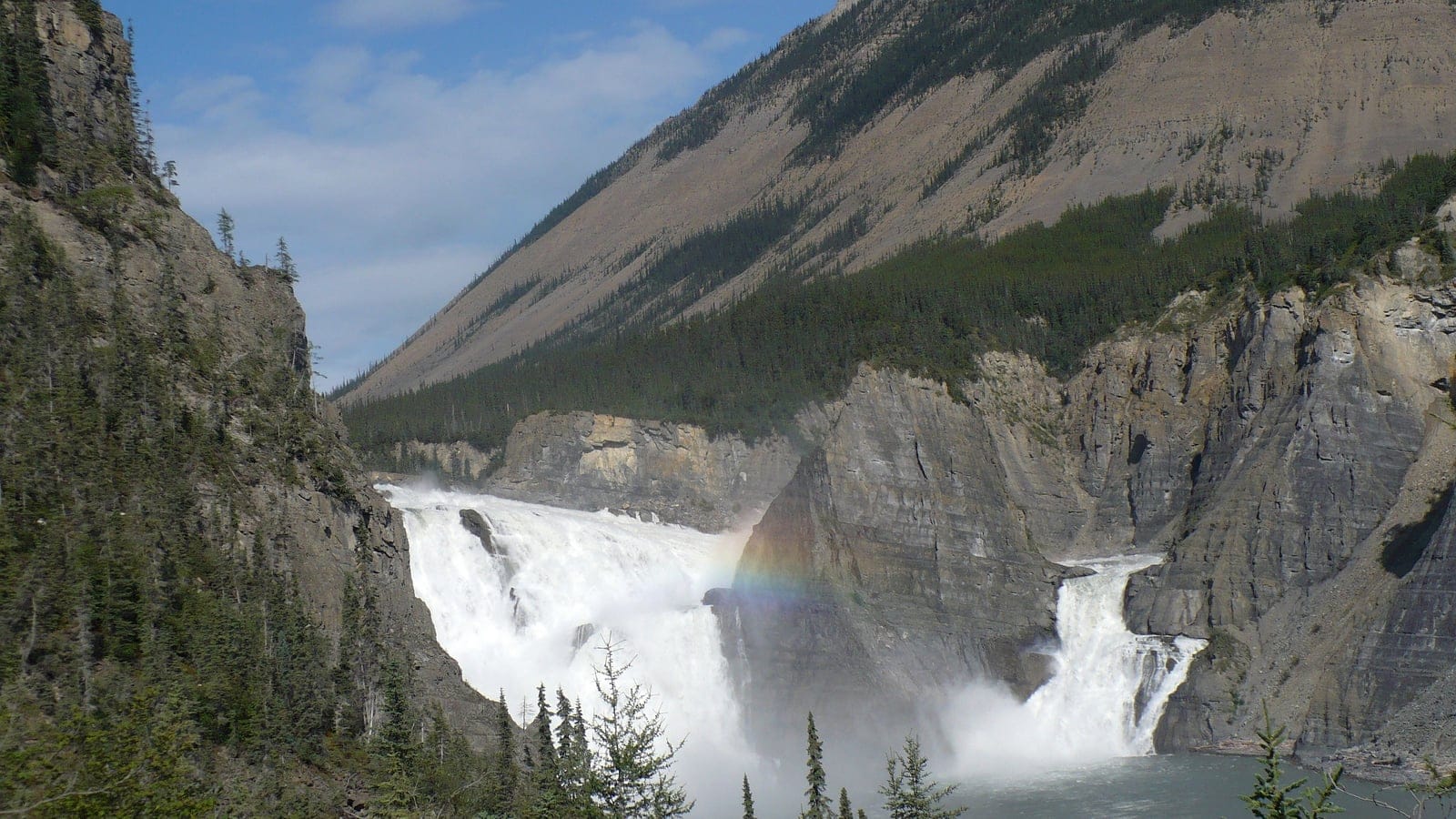 Virginia Falls dropping into a limestone canyon below spruce slopes, Nahanni, Northwest Territories.