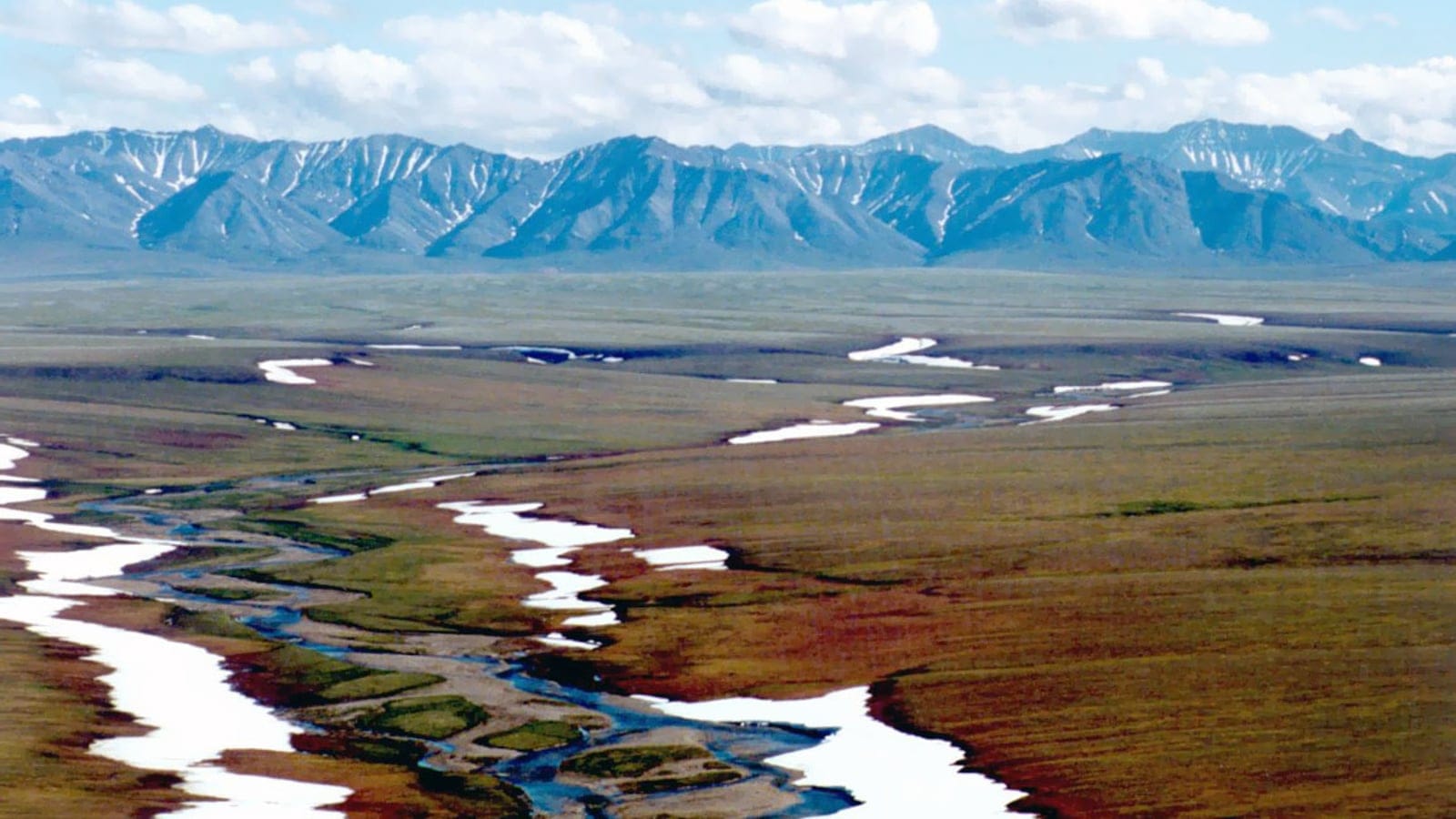 Arctic foothills tundra and braided streams below the Brooks Range in Alaska.