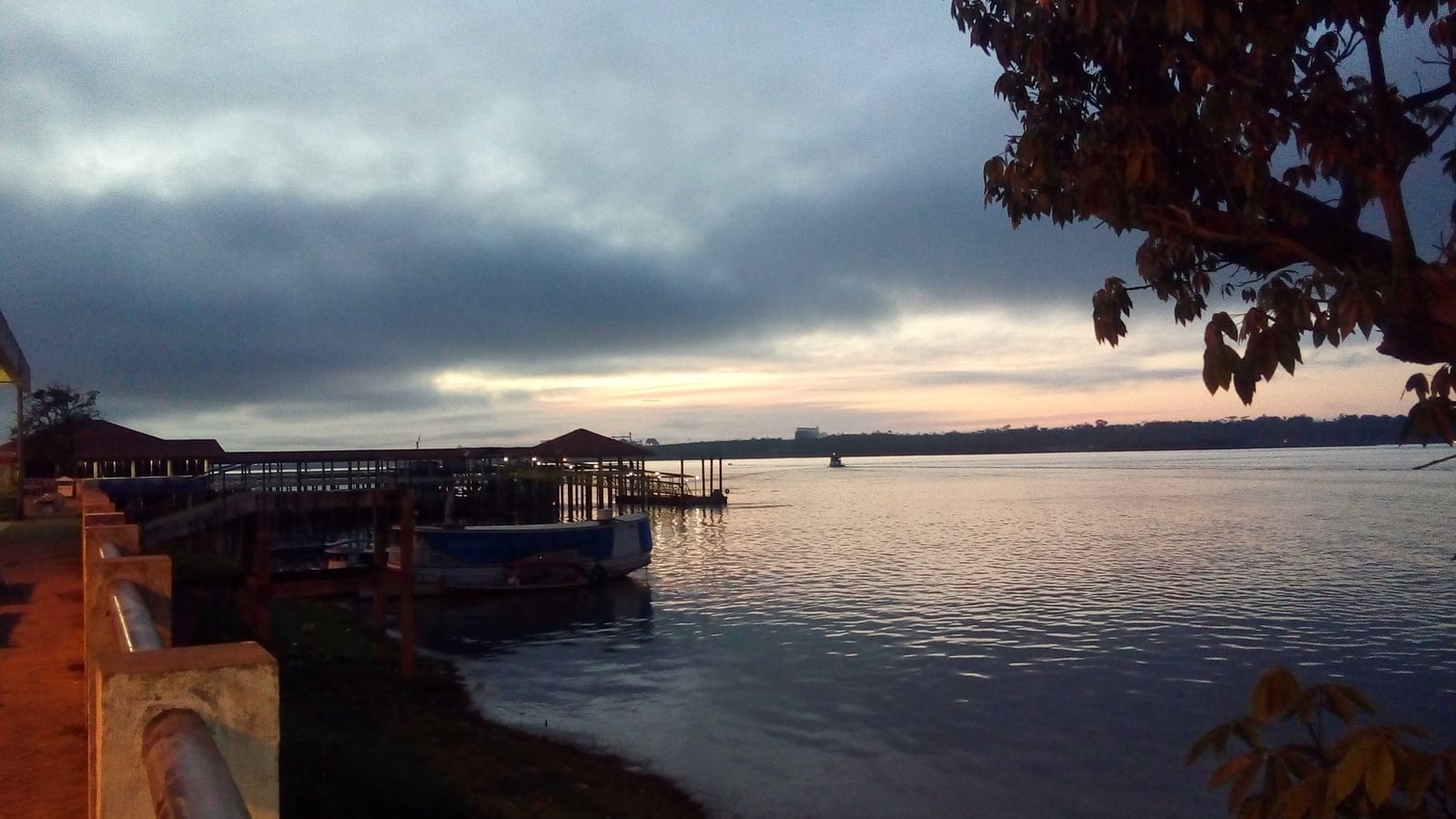 Boats moored at a riverside pier on the Tapajos at dusk, Amazonia National Park, Brazil.