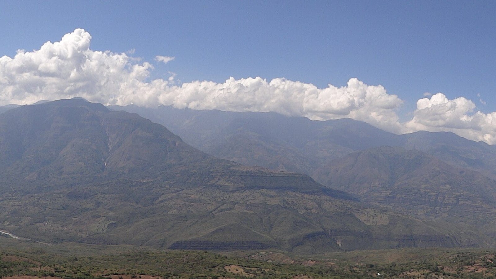 Hazy stacked ridges of the Serrania de los Yariguies above dry scrub near Barichara, Colombia.