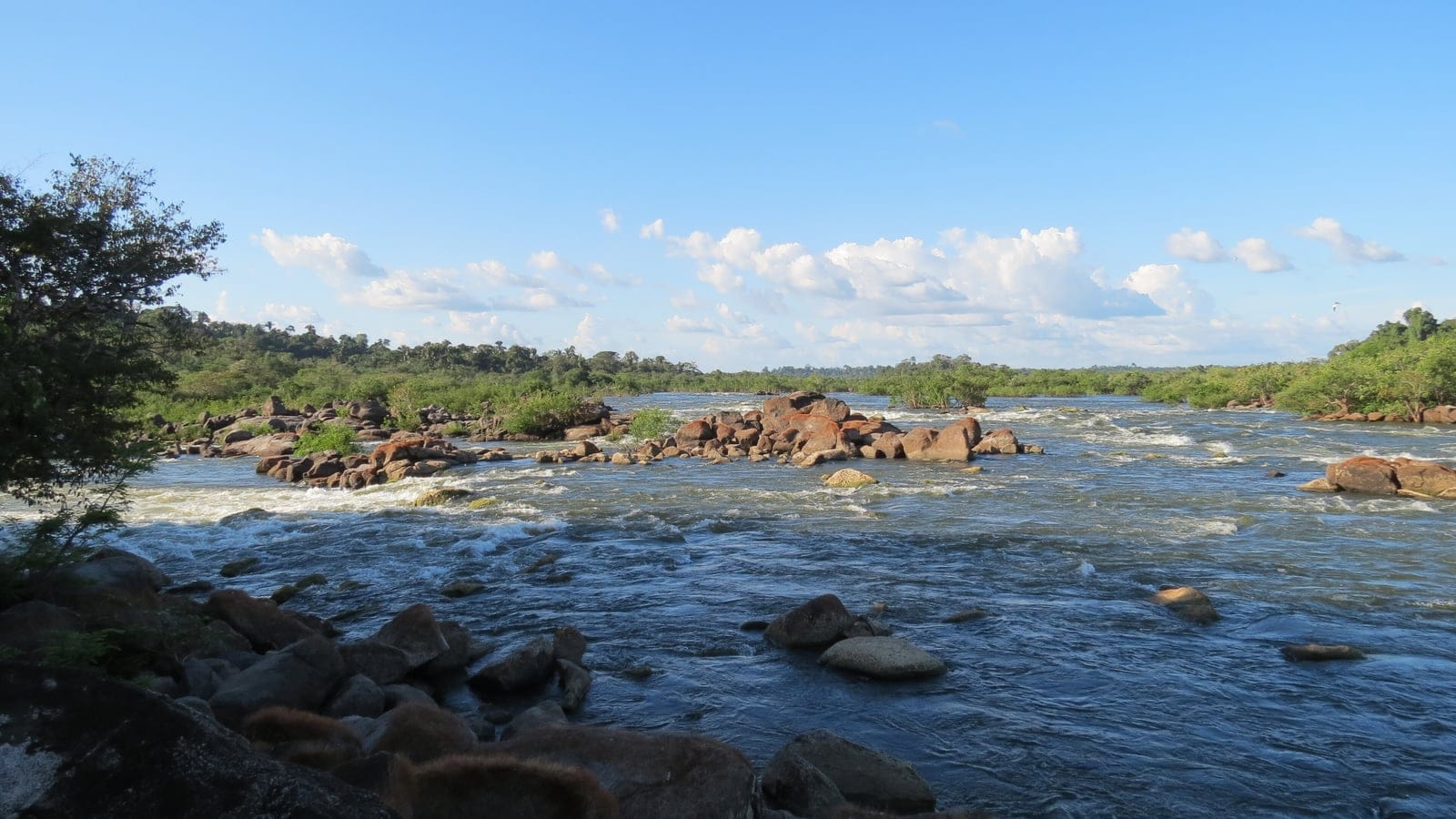 Boulder rapids and a low forest bank on the Rio Xingu at Vitoria do Xingu, Para, Brazil.