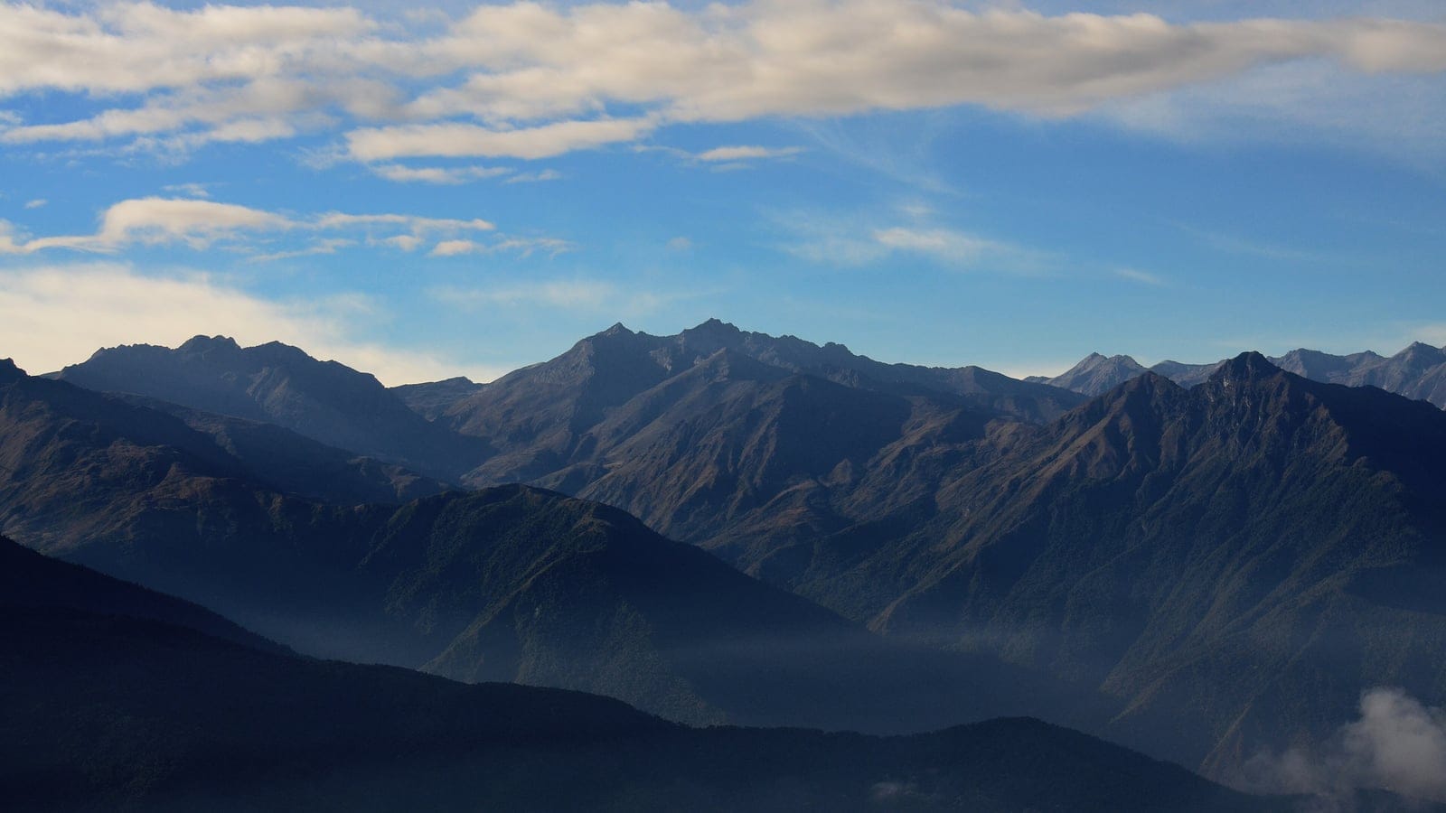 Hazy layered ridges and a bare rocky crest of the Sierra de La Culata under high cloud, Merida, Venezuela.