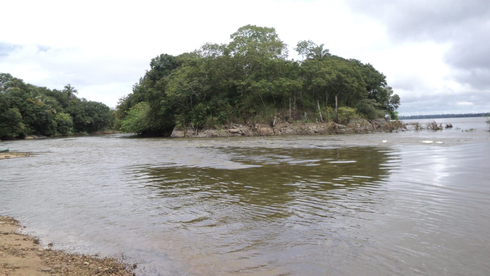 Forested rock island in the brown current of the Rio Tocantins at Sao Joao do Araguaia, Brazil.