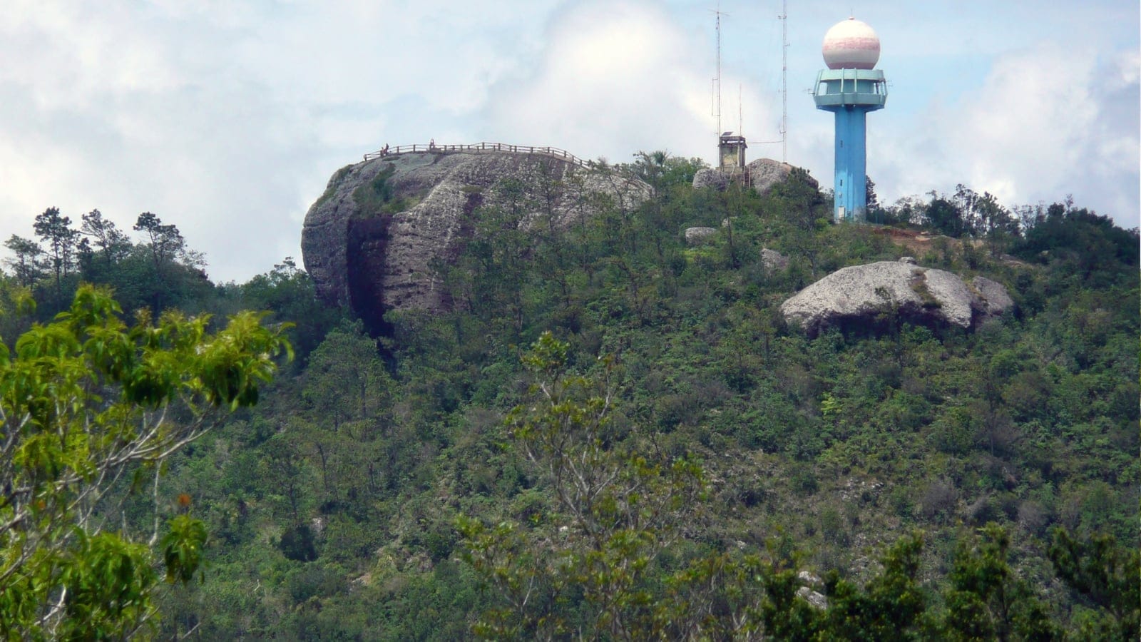 Broadleaf scrub and scattered pines around the rock dome of La Gran Piedra, Sierra Maestra, Cuba.