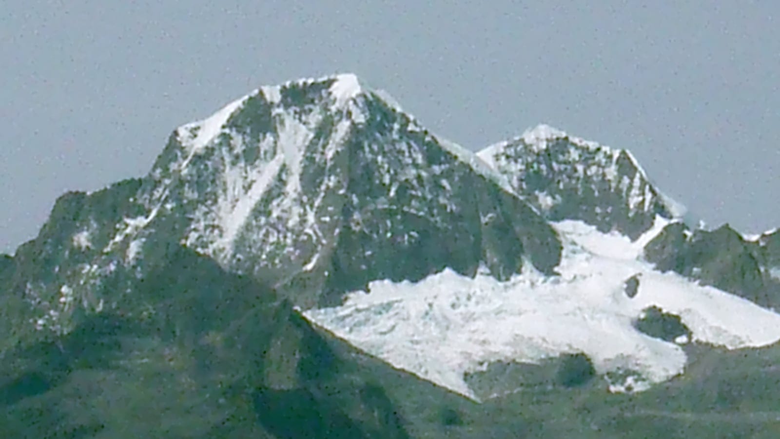 Snowfields and a small glacier below the twin summits of Pico Cristobal Colon and Pico Simon Bolivar, Colombia.