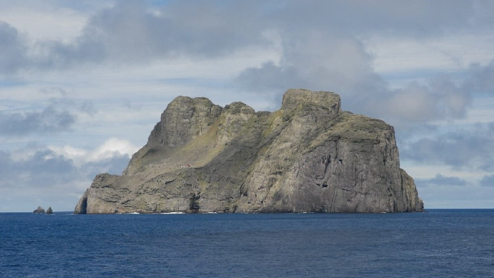 The bare rock mass of Malpelo Island rising from open Pacific swell, Colombia.