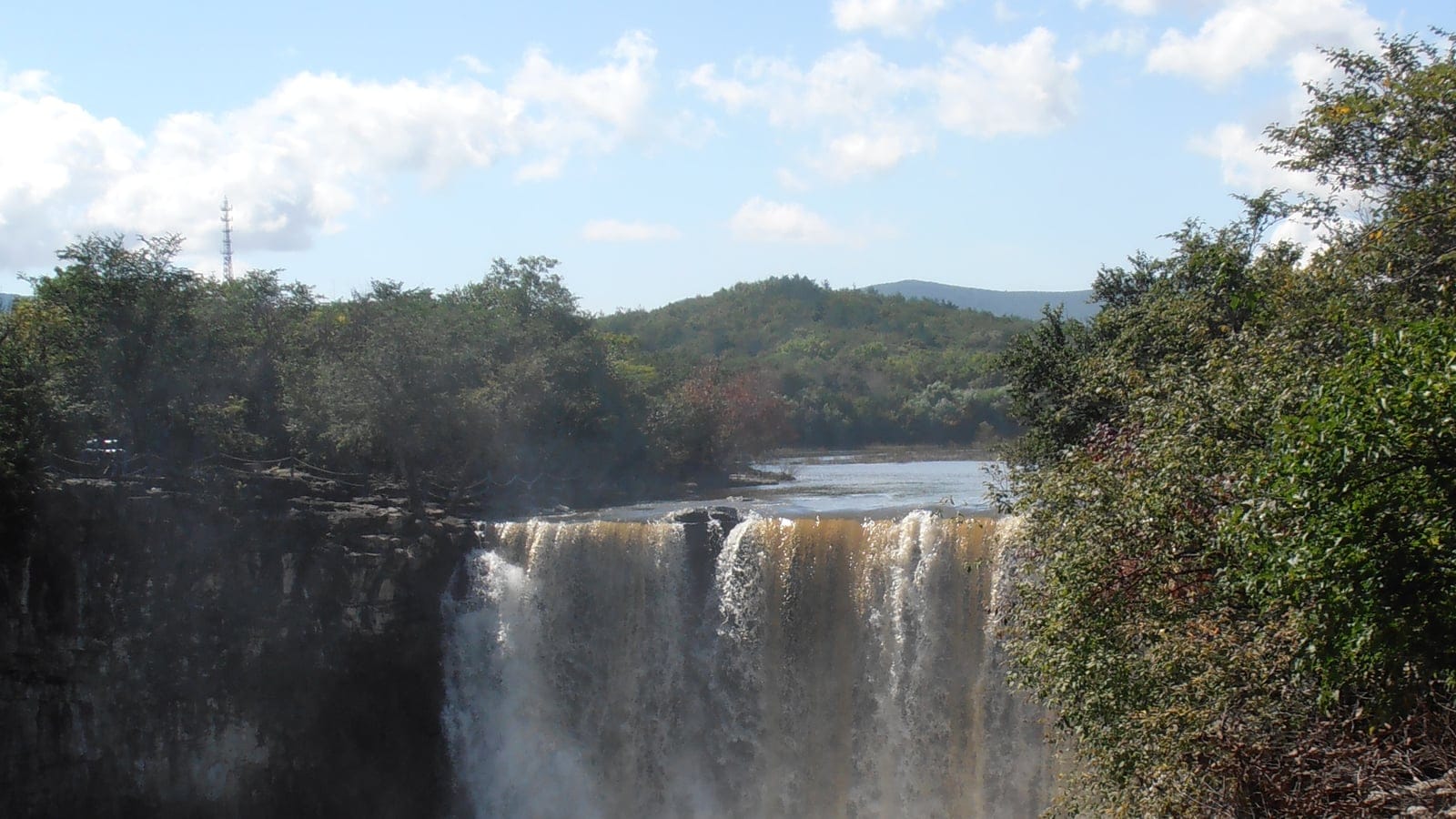 Forested banks above the Diaoshuilou waterfall in Heilongjiang, China.