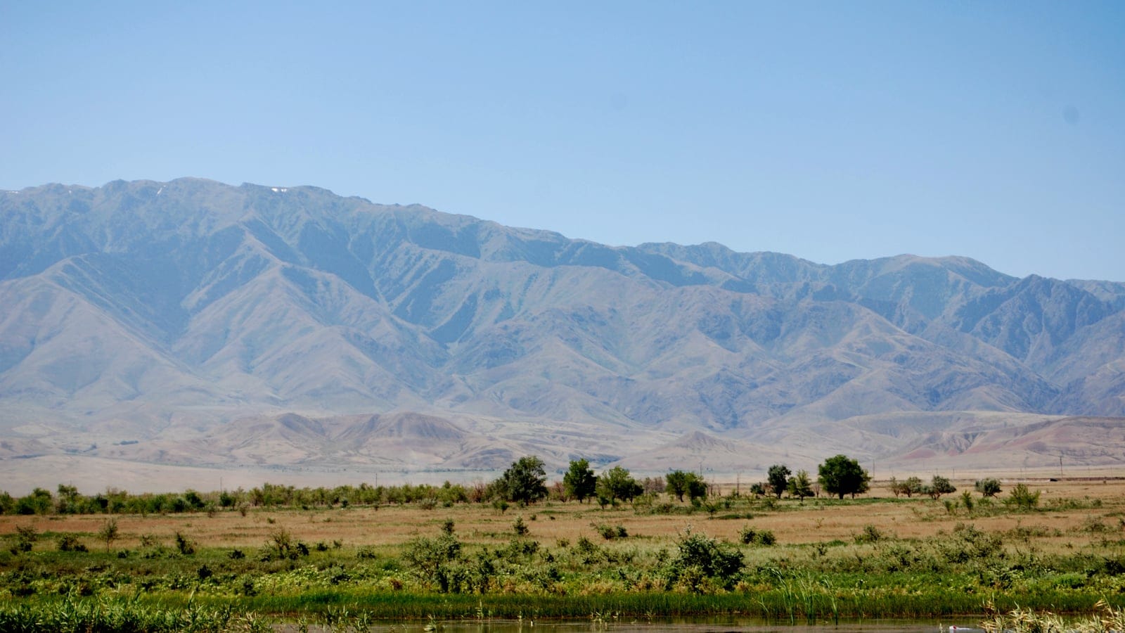 Open Emin Valley steppe and lake landscape in eastern Kazakhstan.