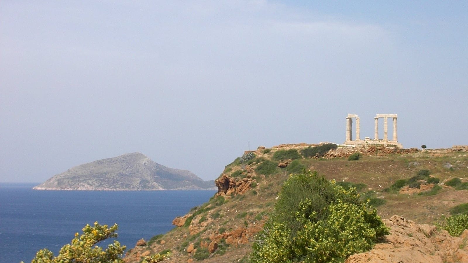 Cape Sounion coastal scrub and rocky Aegean headland in Attica, Greece.