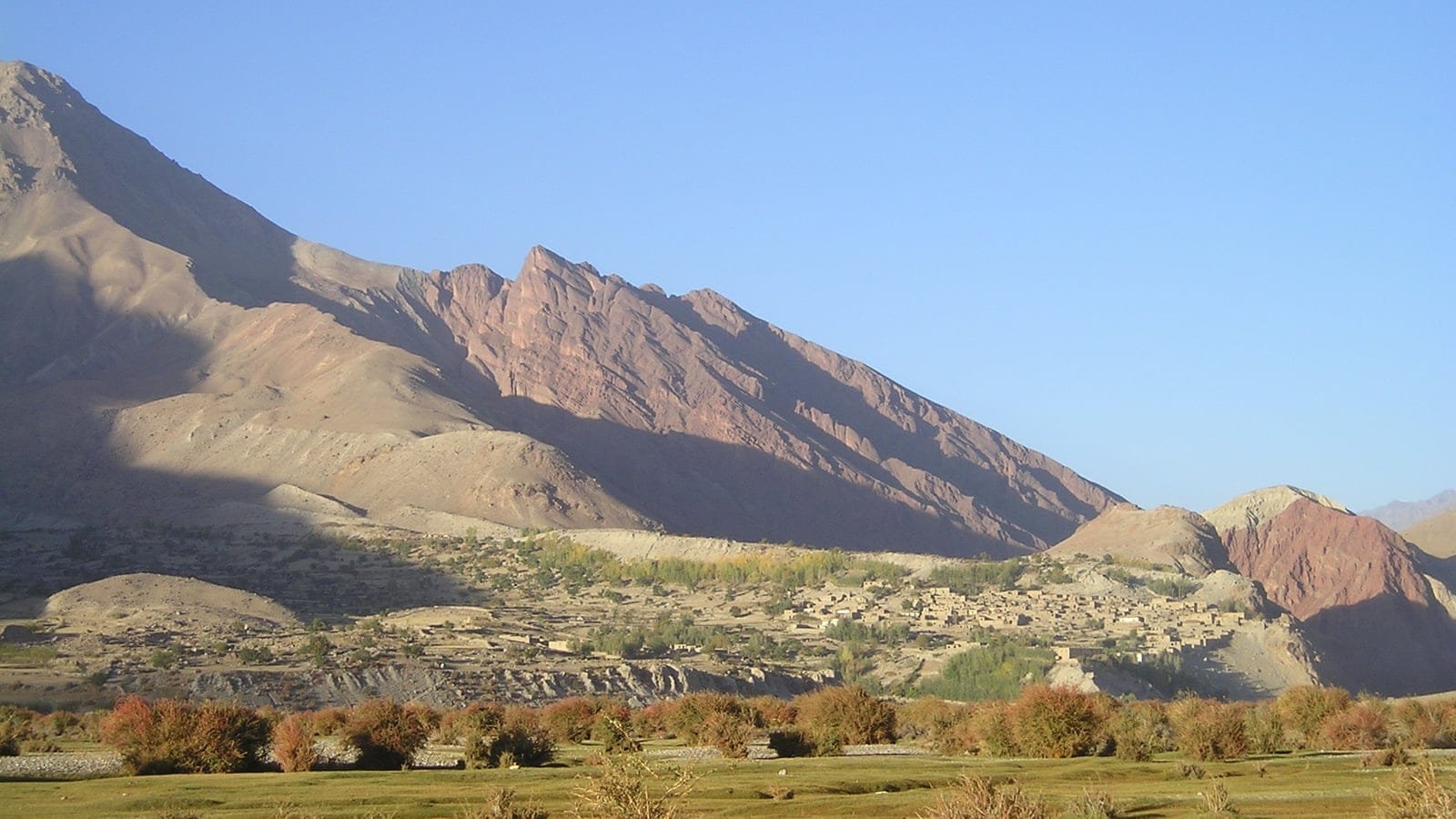 Kuran wa Munjan valley in Badakhshan, Afghanistan, with dry mountain slopes and semi-desert vegetation.