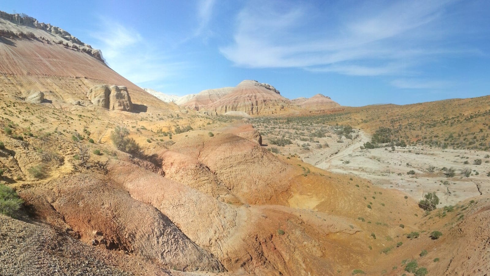 Banded desert badlands with sparse shrubs at Altyn Emel, Kazakhstan.